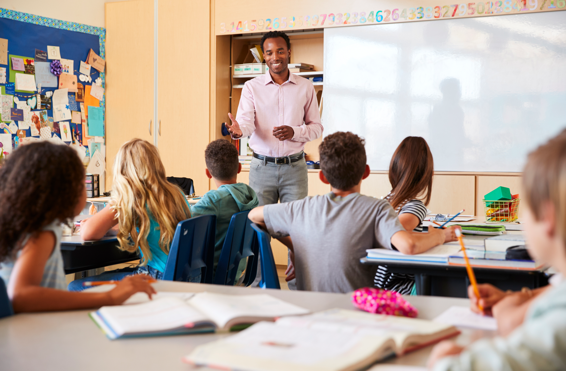 teacher-and-kids-during-a-lesson-at-an-elementary teacher-and-kids-during-a-lesson-at-an-elementary
